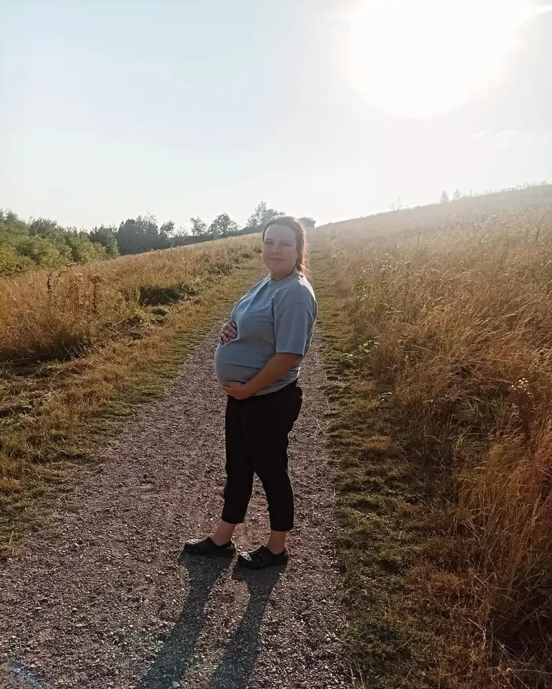 Donna out walking on a field path during her pregnancy